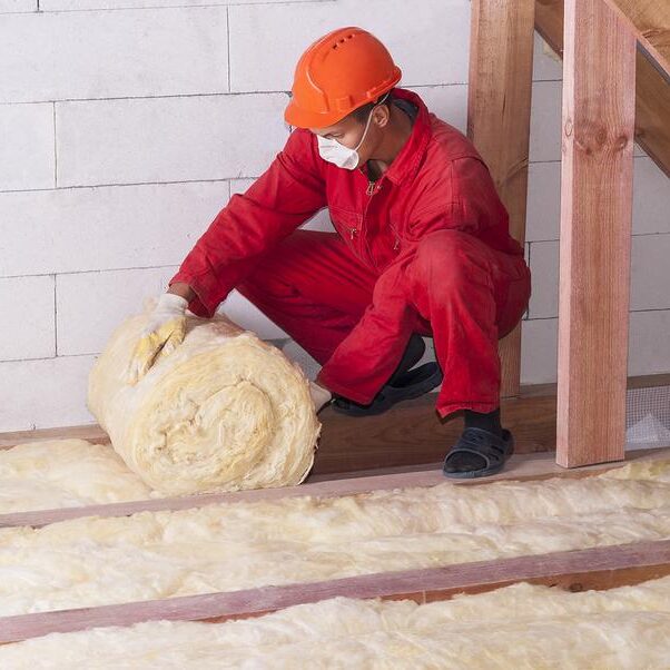 worker rolling the insulation